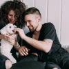 Cute couple with their dog playing