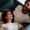 Couple relaxing and laughing at home